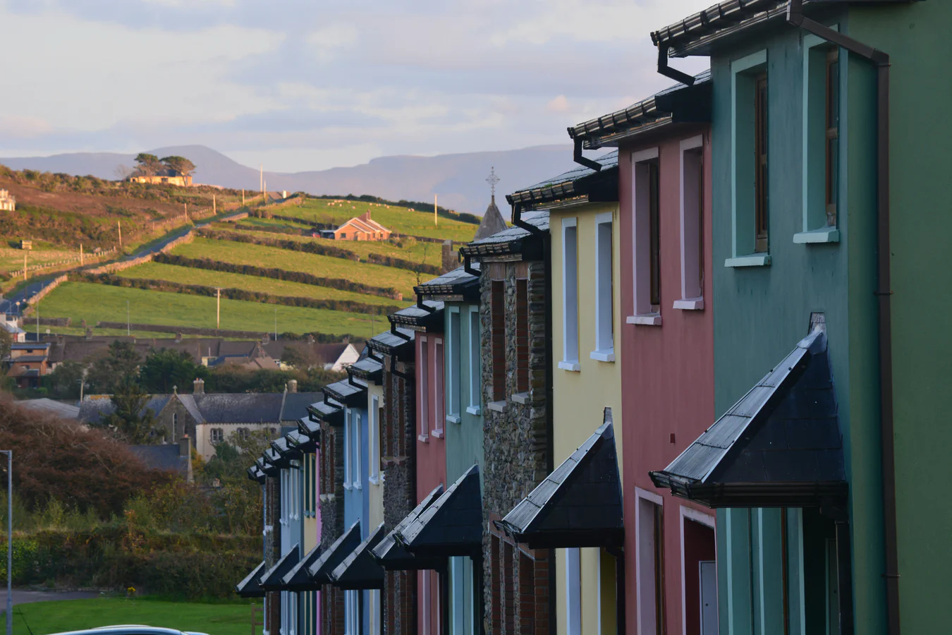 Colourful houses with fields beyond, illustrating the relationship between settlement and countryside.