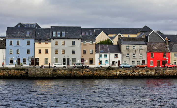 Colourful waterfront buildings; an illustrative image of place and movement.