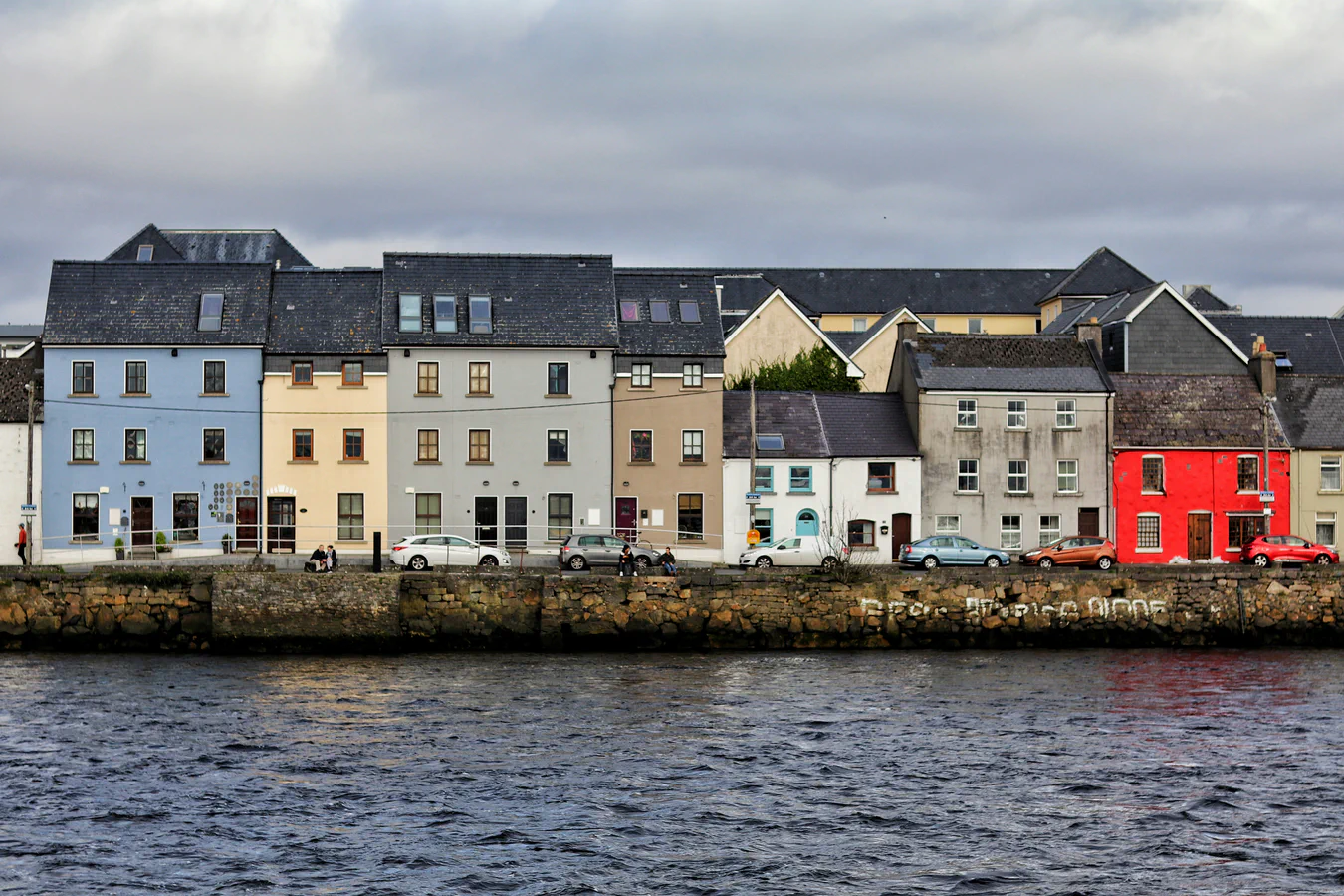 Colourful waterfront buildings; an illustrative image of place and movement.