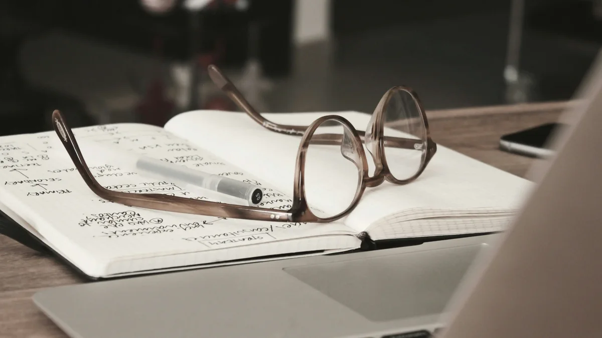 Glasses resting on open notes