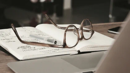Glasses resting on open notes